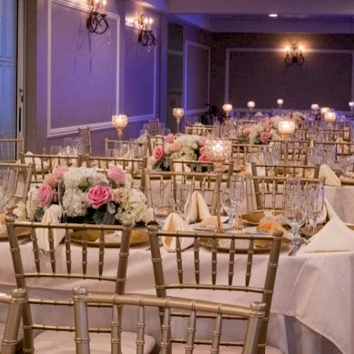 The image shows an elegantly decorated banquet hall with gold chairs, tables set with white linens, floral centerpieces, and candlelit stands.