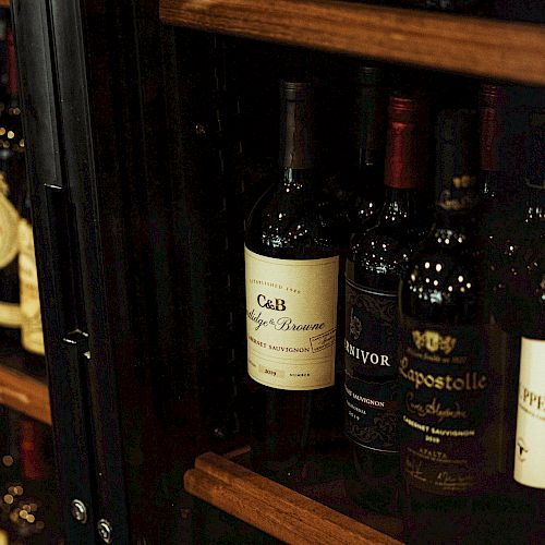 The image shows shelves stocked with various bottles of wine, including labels like Cab, Apestolle, and Uppercut.