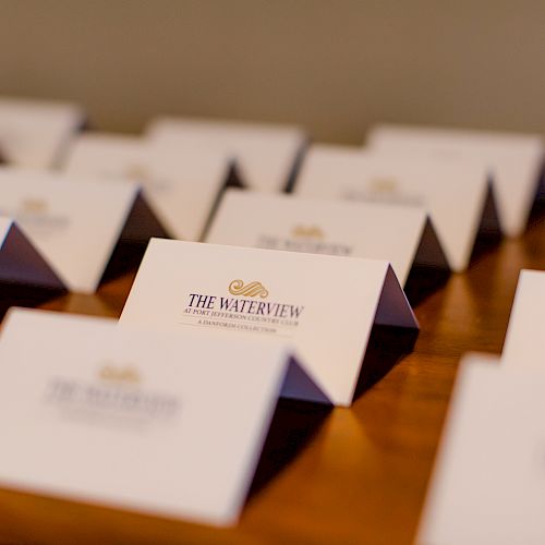 This image shows several folded cards standing upright on a table, printed with "The Waterview" and possibly used as place cards for an event.